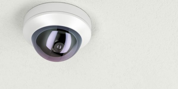 Surveillance camera attached on white ceiling